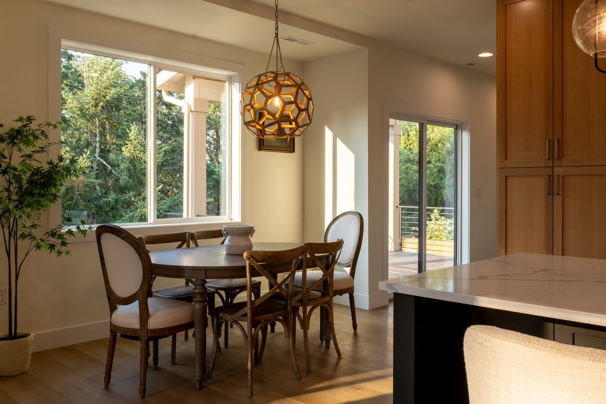 Bright dining room with pendant light and garden views — real estate photography by Hahn Media, Oregon