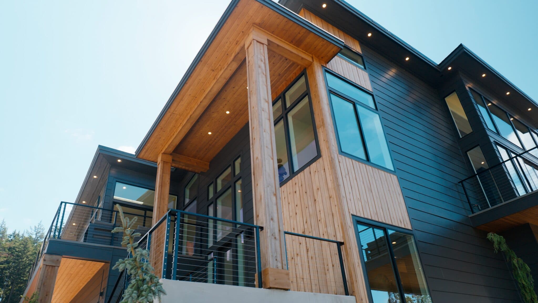 Modern two-story home exterior with wood and dark siding — real estate photography by Hahn Media, Oregon